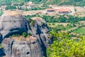 Group of swallows sitting on high growing mountain tree with panoramic view of scenic Meteora rock formations landscape and valley