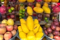 Group of sweet Tropical fruit. Fresh juicy mangos. Fruit background. Mangos, apples and limes at outdoor farmers market Royalty Free Stock Photo