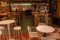 a group of tables and chairs sit in a room that has lots of wood tables