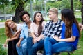 Group of talking latin american and african young adults Royalty Free Stock Photo