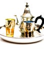 Group of teapot and glasses of oriental tea on a tray on white background