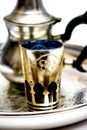 Group of teapot and glasses of oriental tea on a tray on white background