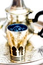 Group of teapot and glasses of oriental tea on a tray on white background