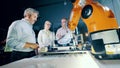 A group of technicians are working with robotized equipment