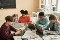 Group of teen schoolchildren using computers in classroom studying Royalty Free Stock Photo