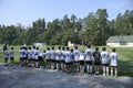 Group of teenage football players in sport wears looking at the soccer field