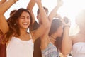 Group Of Teenage Friends Dancing Outdoors Against Sun Royalty Free Stock Photo