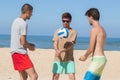 Group teenage friends playing volleyball on beach Royalty Free Stock Photo