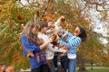 Group Of Teenage Friends Throwing Leaves