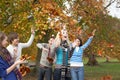 Group Of Teenage Friends Throwing Leaves In Autumn