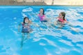 Group of 3 teenage girlfriends having fun in swimming pool Royalty Free Stock Photo