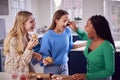 Group Of Teenage Girls Eating And Having Fun Playing With Cupcakes In Kitchen At Home Royalty Free Stock Photo