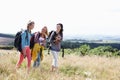 Group Of Teenage Girls Hiking In Countryside With Dog