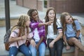 Group of Teenage girls laughing and talking together at school Royalty Free Stock Photo