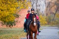 Group of teenage girls riding horse in autumn park Royalty Free Stock Photo