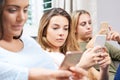 Group Of Teenage Girls Using Mobile Phones At Home Royalty Free Stock Photo