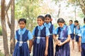 Group of teenage kids in uniform holding hands while going to playground at school - concept of friendship, taking break Royalty Free Stock Photo