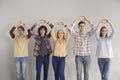 Group of teenage student showing love sympathy make heart gesture studio shot Royalty Free Stock Photo