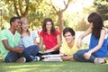 Group Of Teenage Students Chatting In Park