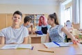 Group of teenage students in the classroom sitting at their desks Royalty Free Stock Photo