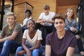 Group Of Teenage Students Socialising On College Campus Together