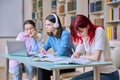 Group of teenage students study at their desks in library class Royalty Free Stock Photo