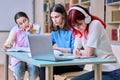 Group of teenage students study at their desks in library class Royalty Free Stock Photo