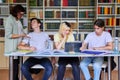 Group of teenage students studying in library class with female teacher mentor Royalty Free Stock Photo