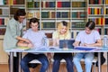 Group of teenage students studying in library class with female teacher mentor Royalty Free Stock Photo