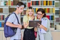 Group of teenage students and a teacher talking in the library Royalty Free Stock Photo