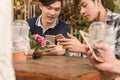 Group of teenager adding friend play social media with smartphone together in coffee shop