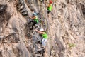 Group Of Teenager Climbers Climbing A Rock Wall