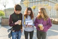 Group teenagers boy and two girls, with a notepad with handwritten word start