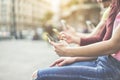 Group of teenagers friends watching mobile phones in city - Young people addiction to technology trends - Alienation moment for