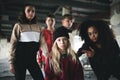 Group of teenagers gang standing indoors in abandoned building, bullying concept. Royalty Free Stock Photo