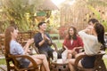 Group of 6 teenagers having fun together without liquor in cafe