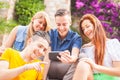 Group of teenagers laughing and looking at a smart phone Royalty Free Stock Photo