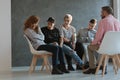 A group of teenagers looking at a withdrawn, lacking self-esteem girl Royalty Free Stock Photo