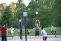 Group of teenagers playing beach volleyball game