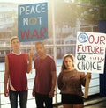 Group of teenagers protesting demonstration holding posters antiwar justice peace concept Royalty Free Stock Photo