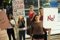 Group of teenagers protesting demonstration holding posters antiwar justice peace concept