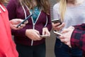 Group Of Teenagers Sharing Text Message On Mobile Phones Royalty Free Stock Photo