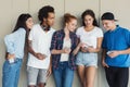 Group Of Teenagers Sharing Text Message On Mobile Phones Royalty Free Stock Photo