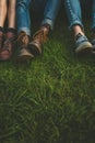 Group of teenagers sitting on the lawn, Close up of body parts. Concept of lifestyle, freedom or relaxation