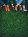 Group of teenagers sitting on the lawn, Close up of body parts. Concept of lifestyle