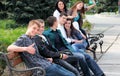 Group of teenagers sitting outside