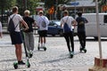 Teenages speeding through city with electric scooters