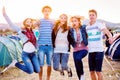 Group of teenagers at summer music festival, jumping Royalty Free Stock Photo