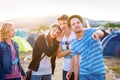 Group of teenagers at summer music festival, sunny day Royalty Free Stock Photo