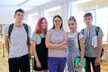 Group of teenagers with teacher, portrait of students and tutor in classroom